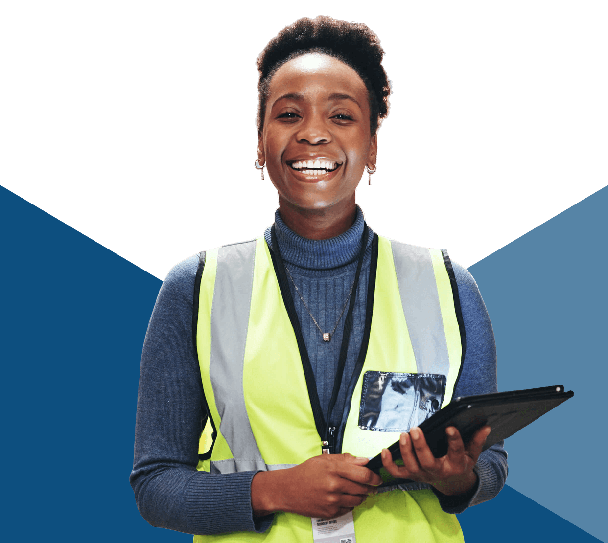 Smiling worker in safety vest holding tablet.
